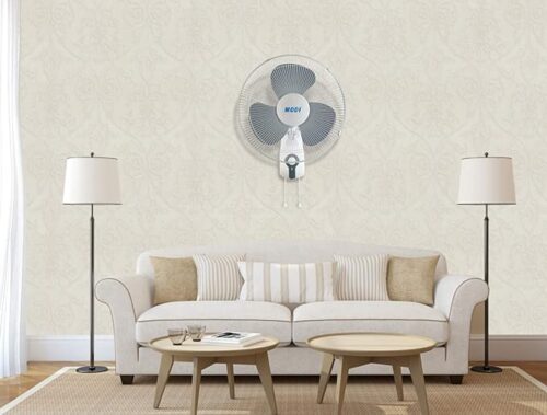 a white couch and a fan in a living room