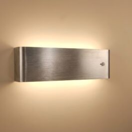 Close-up of a rechargeable sconce showing the USB-C charging port and 3-way toggle switch for On, Off, and Auto modes