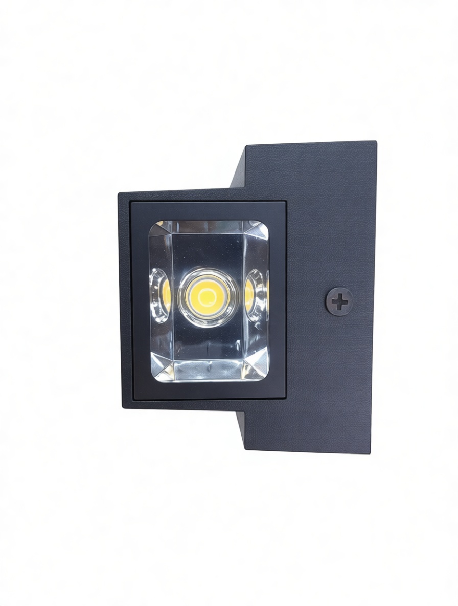 Close-up of the COB LED light source and reflective lens on a modern wall sconce.