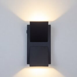 Modern black up and down wall light projecting wide light beams on a wall.