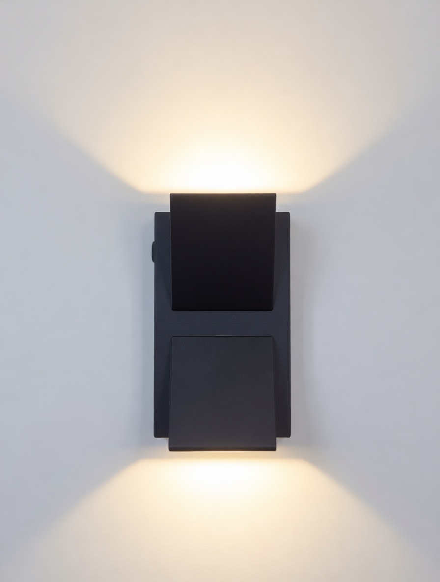 Modern black up and down wall light projecting wide light beams on a wall.