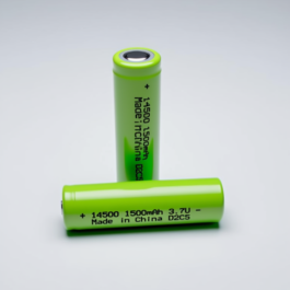 Close-up view of the positive terminal of a green 14500 3.7V lithium-ion battery.