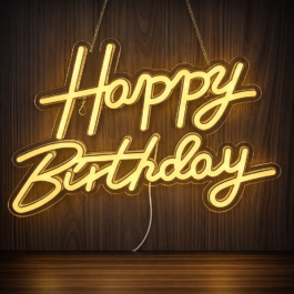 Warm white Happy Birthday neon sign illuminated against a dark wood paneled wall, showing high contrast and luxury party vibes.